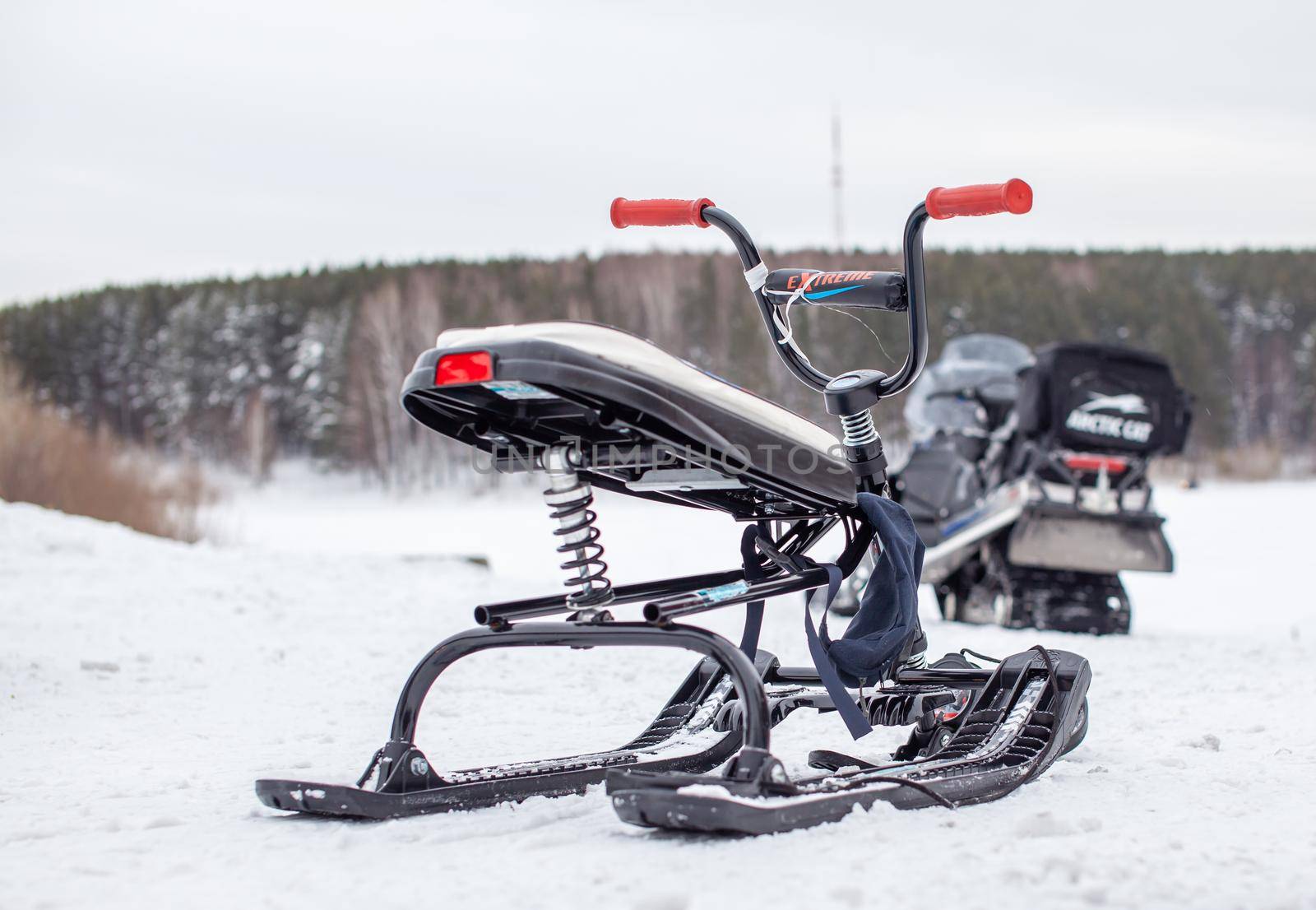 The children's snowmobile is ready for children to ride. Entertainment activities for children riding in the snow in winter