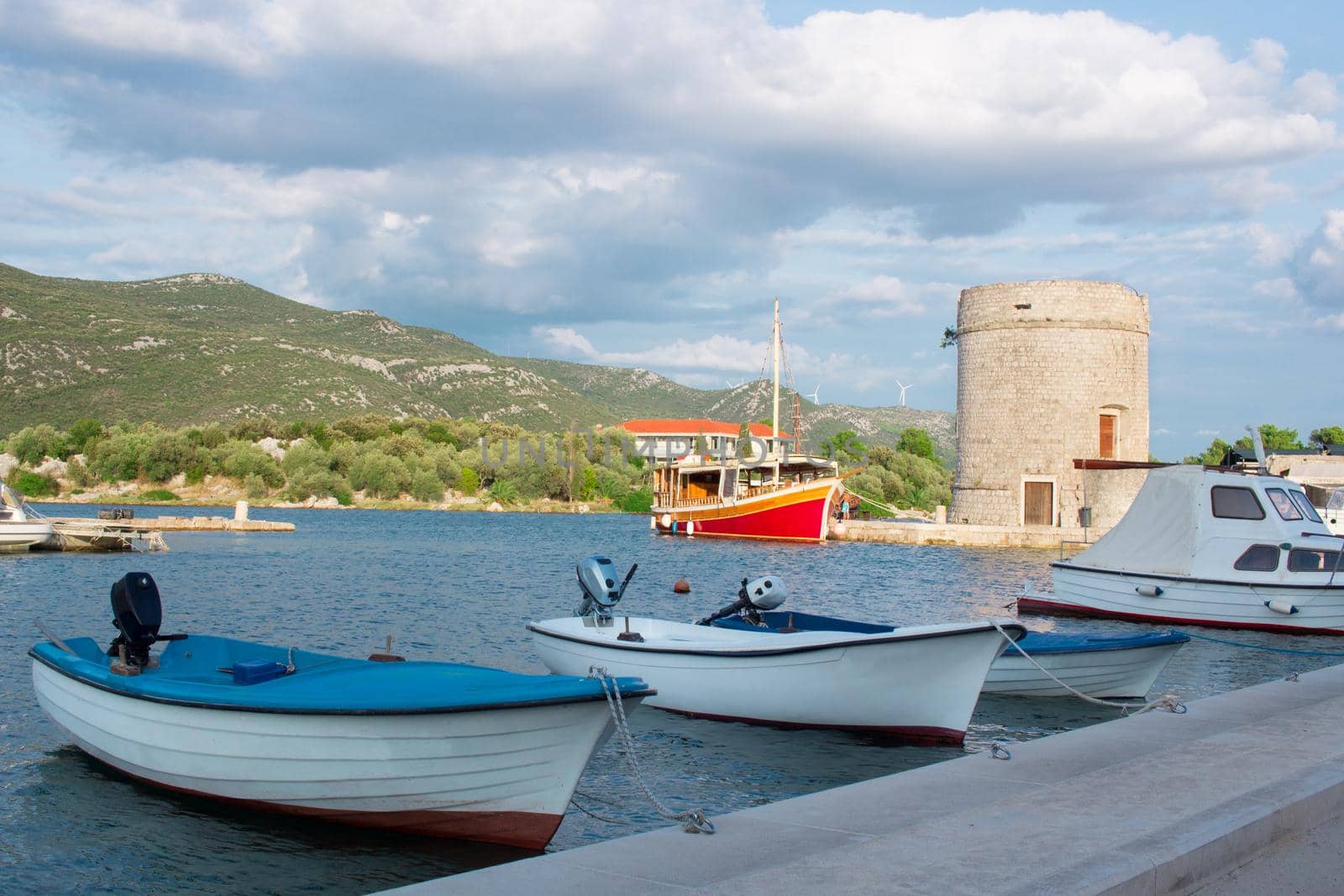 Small fishing boats in Mediterranean Adriatic sea bay tied to town quay in Croatia