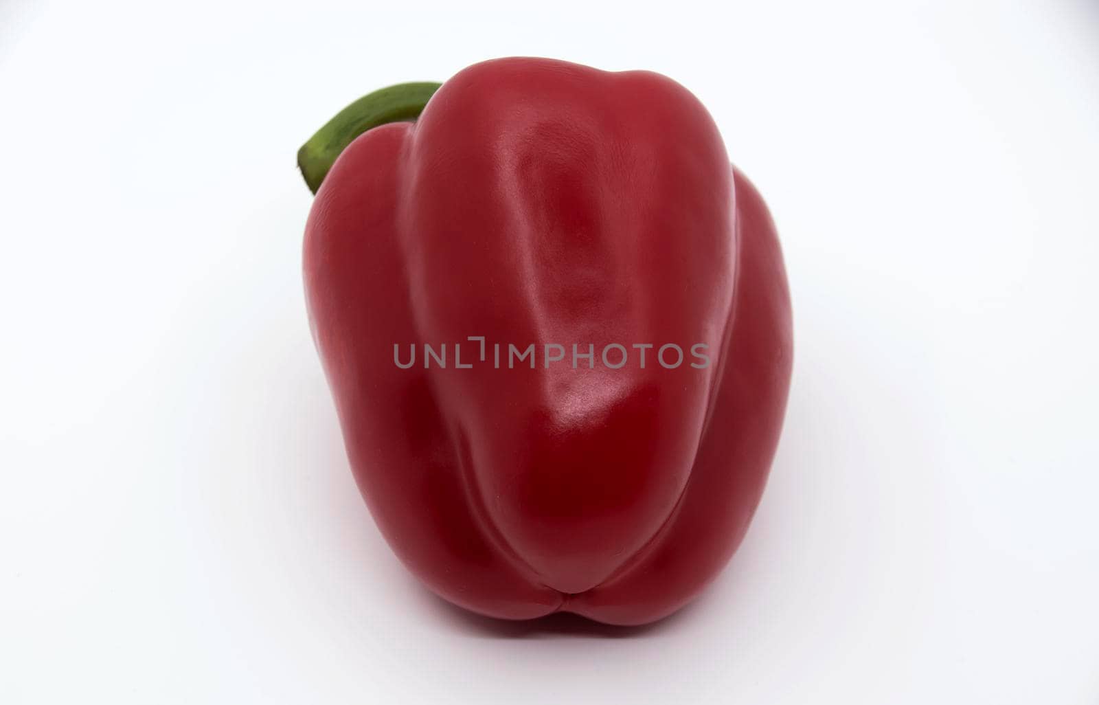 Ripe juicy sweet bell pepper on a white background.