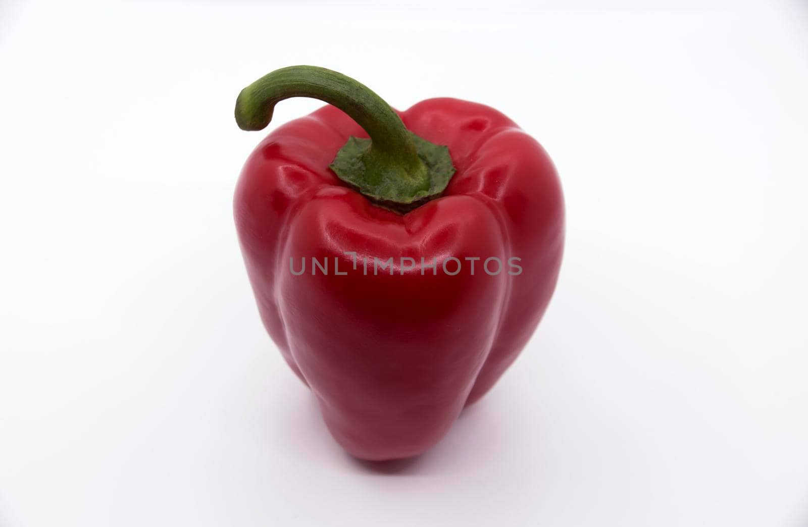 Ripe juicy sweet bell pepper on a white background.