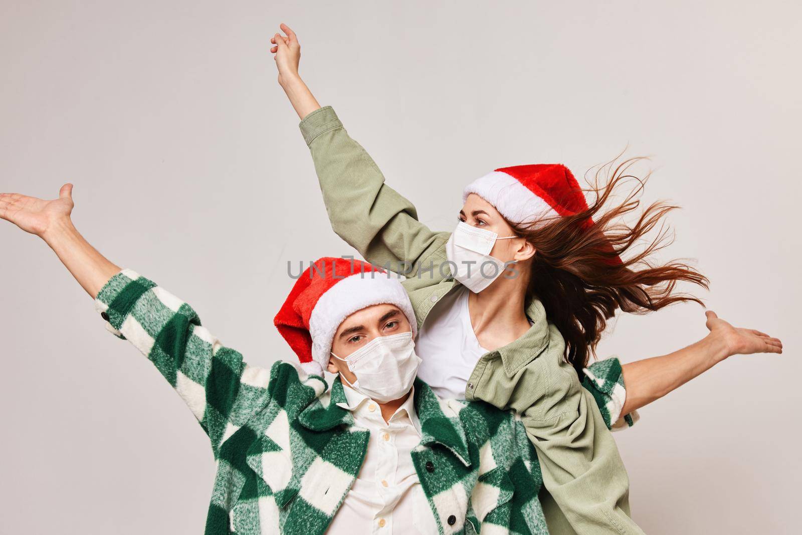 Christmas mood man and woman fun holiday hat medical mask. High quality photo