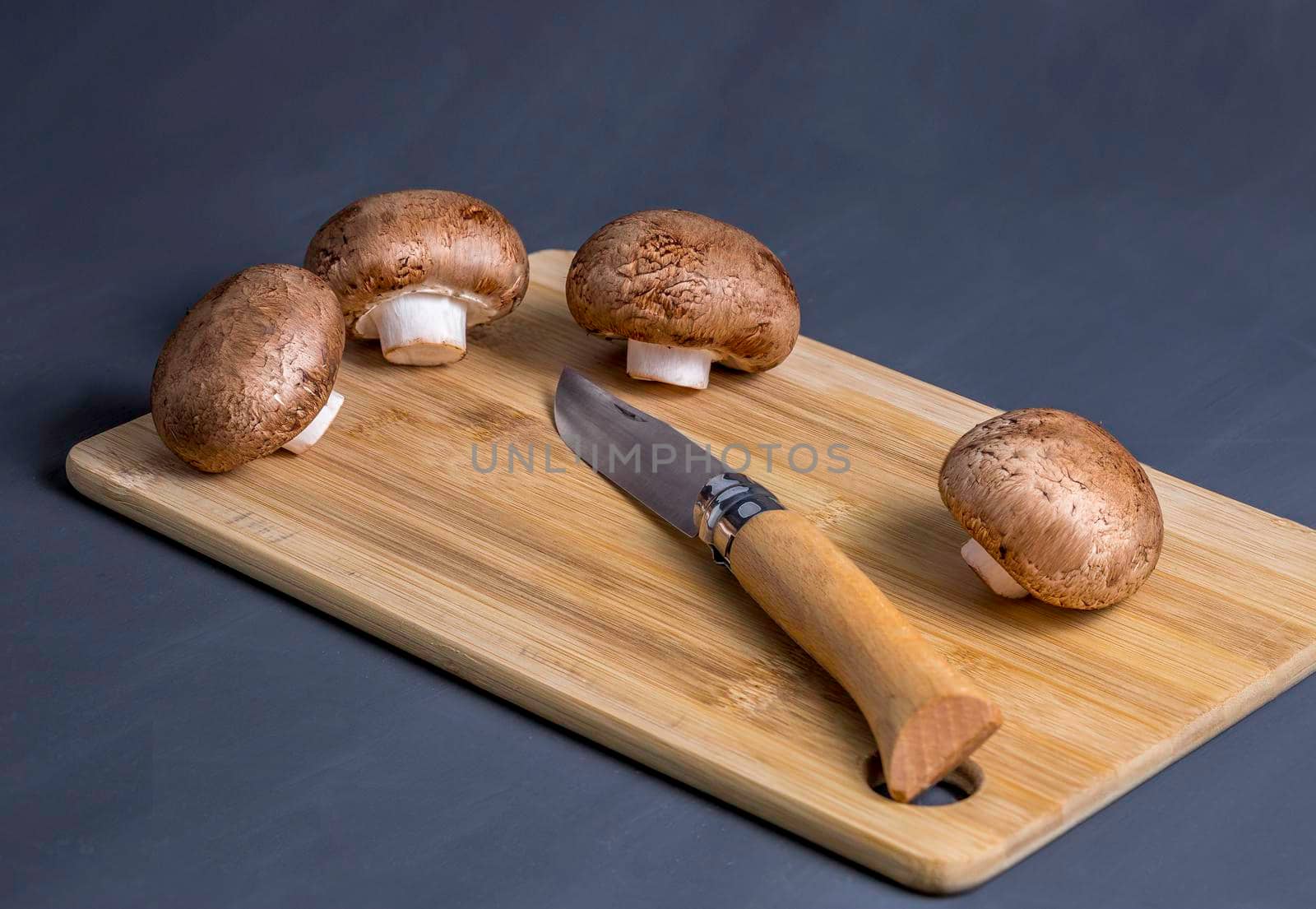 Royal champignons, Parisian champignons, mushrooms on wooden chopping board. by galinasharapova