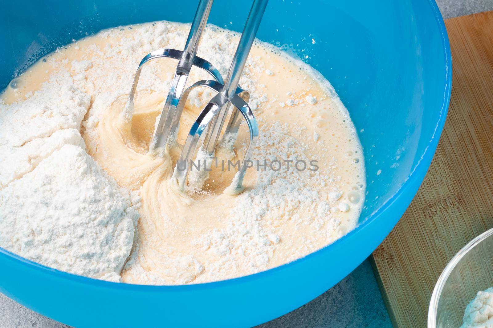 Kneading baking dough with an electric mixer.