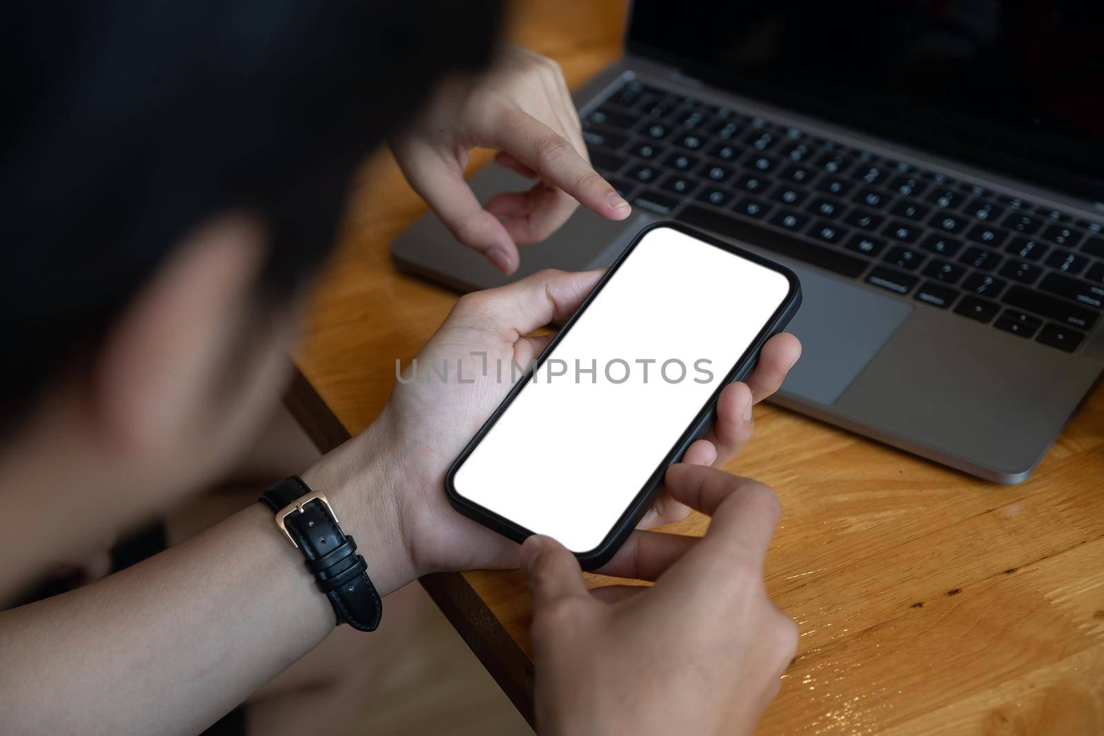 Man holding and touch smartphone blank screen in the mall. Take your screen to put on advertising by nateemee