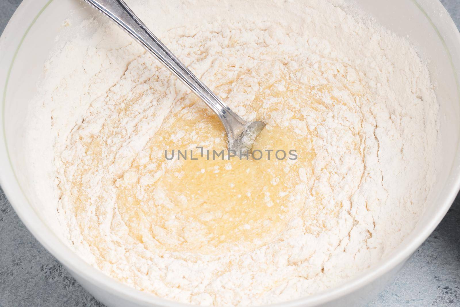 Making homemade pie dough. Mixing ingredients in a bowl.