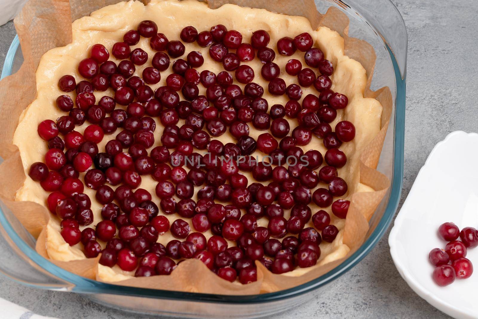 Homemade baking. Making a sweet cranberry pie in a glass baking dish.
