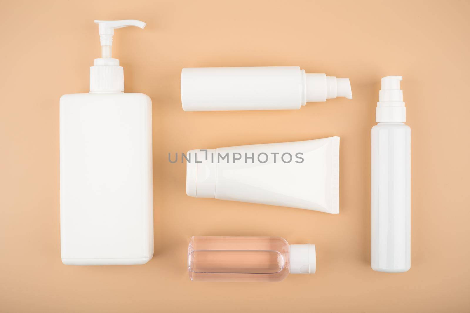 Flat lay with a set of cosmetic products for daily skin and body care routine on beige background by Senorina_Irina