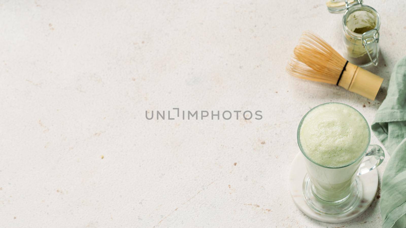 Green foam texture extreme close up as background. Perfect green matcha tea latte foam with bubbles macro shoot. Copy space for text. Horizontal banner