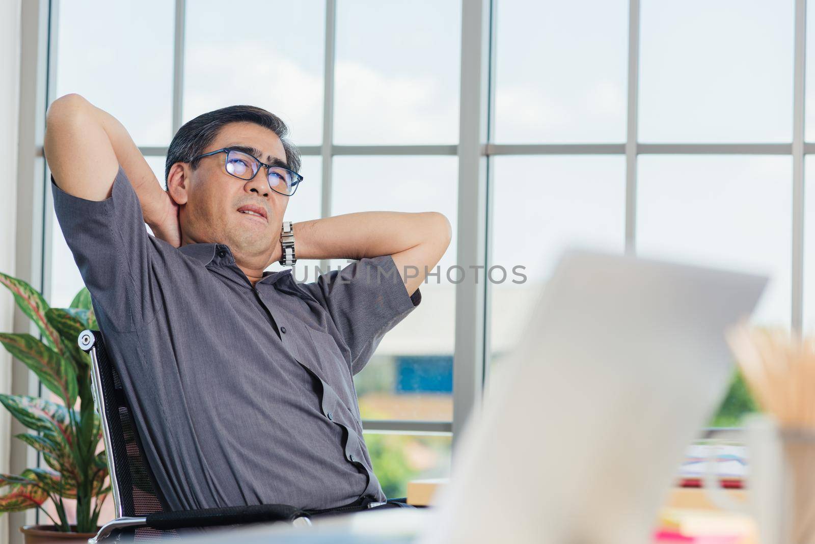 businessman working with laptop computer has a problem with neck pain by Sorapop