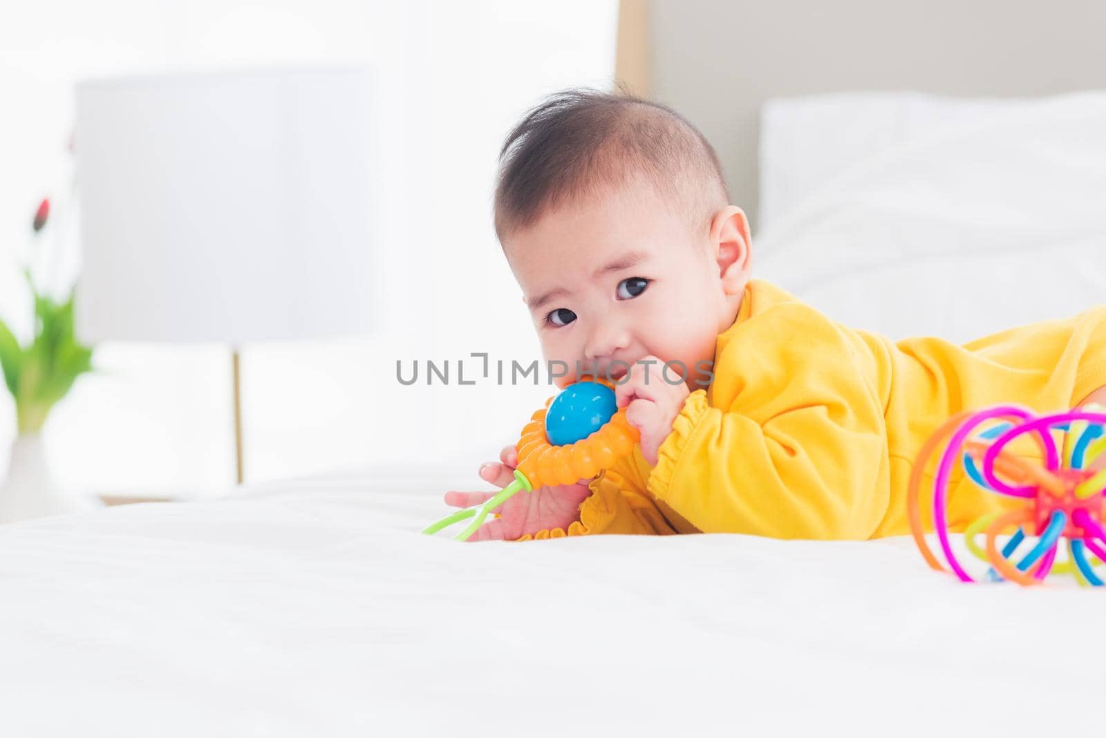 newborn little baby prone on the bed at home by Sorapop