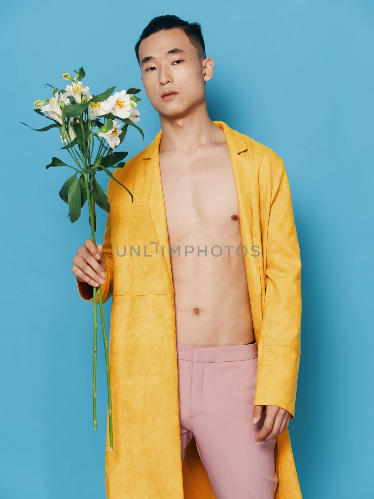 Asian man with a bouquet of white flowers gifts holidays. High quality photo