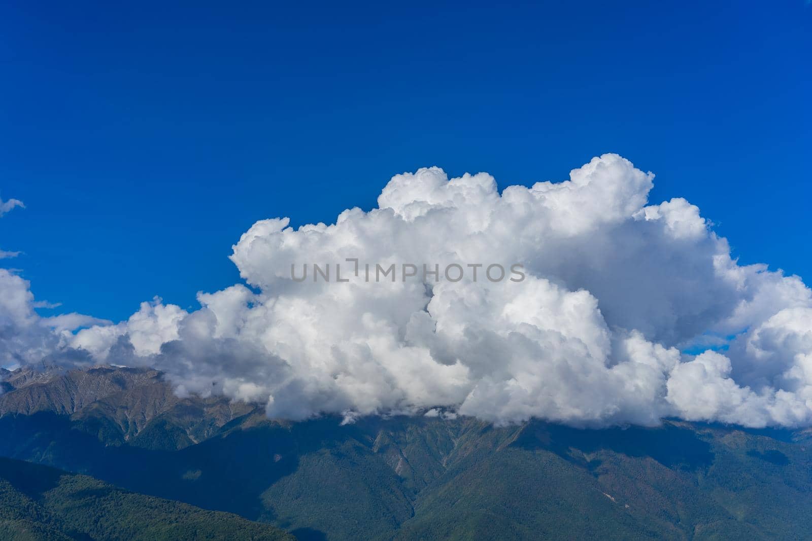 Mountain landscape against cloudy blue sky in Krasnaya Polyana Sochi.