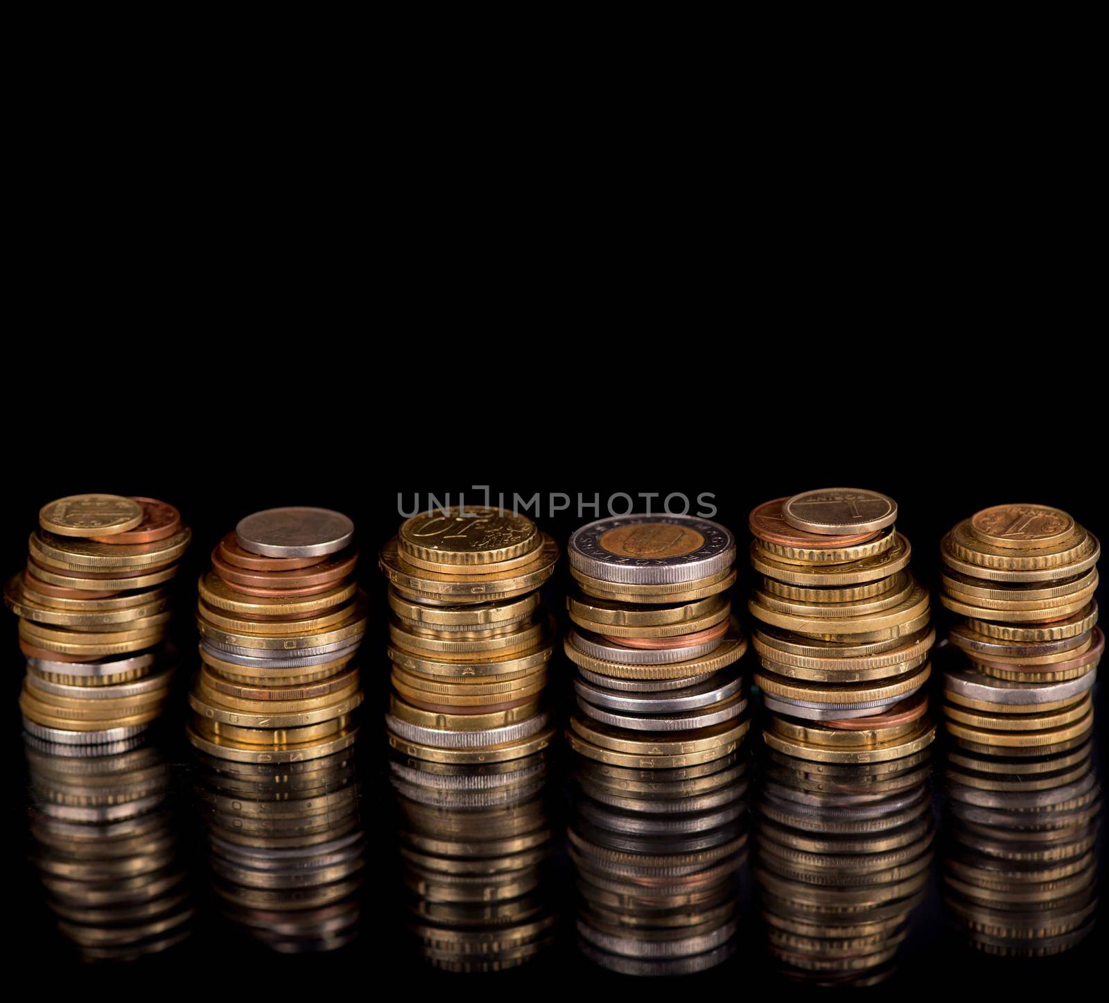 Stack Coins Over Black Background by aprilphoto