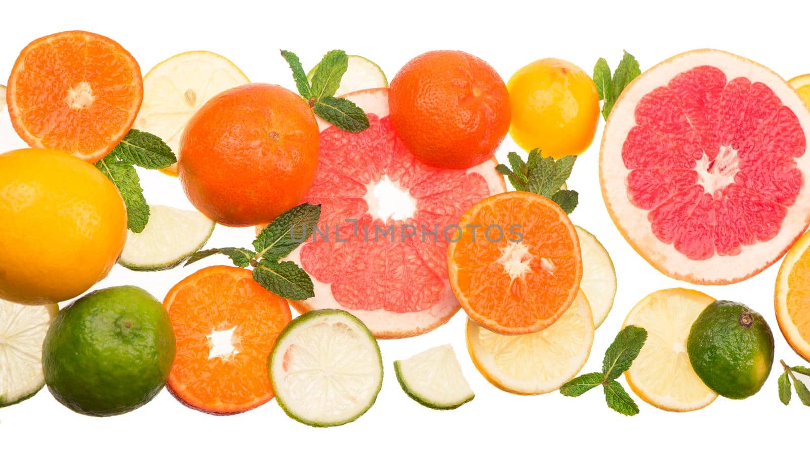 Mixed citrus fruit including lemons, limes, grapefruit, and tangerines with mint sprigs isolated on a white background by aprilphoto