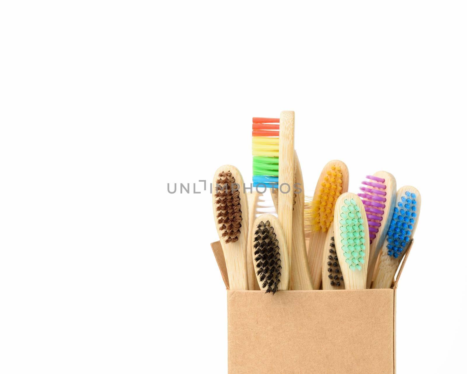 multicolored wooden toothbrushes on a white background, plastic rejection concept, zero waste, close up