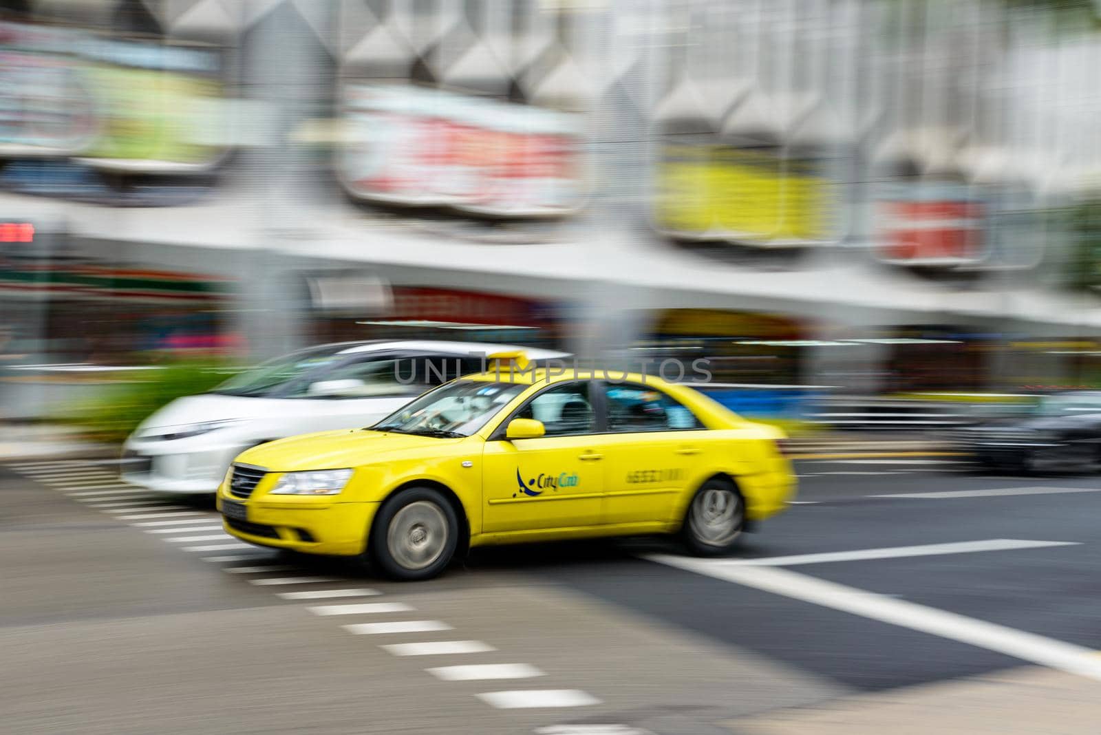 SINGAPORE - CIRCA JANUARY 2016: Yellow Hyundai taxi with motion blur.