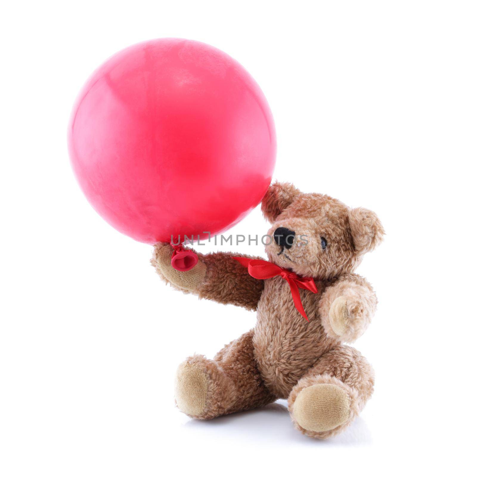 A small brown Teddy Bear playing with red balloon