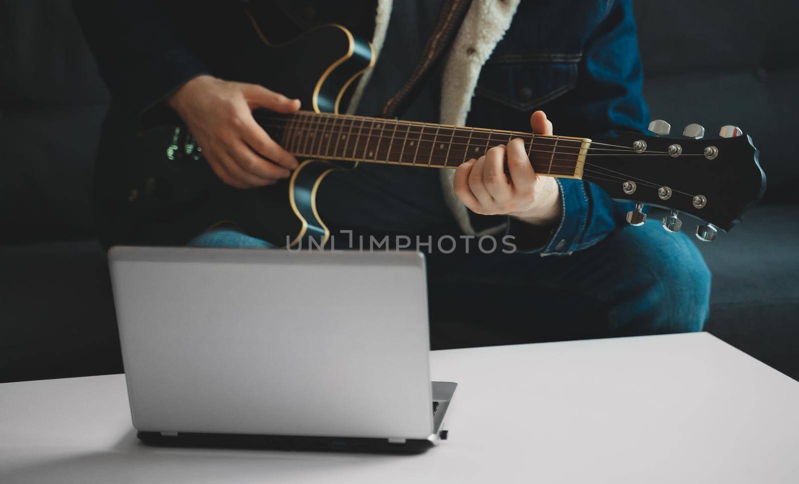 Teacher shows how to play the guitar. Remote online lesson. by dmitrimaruta