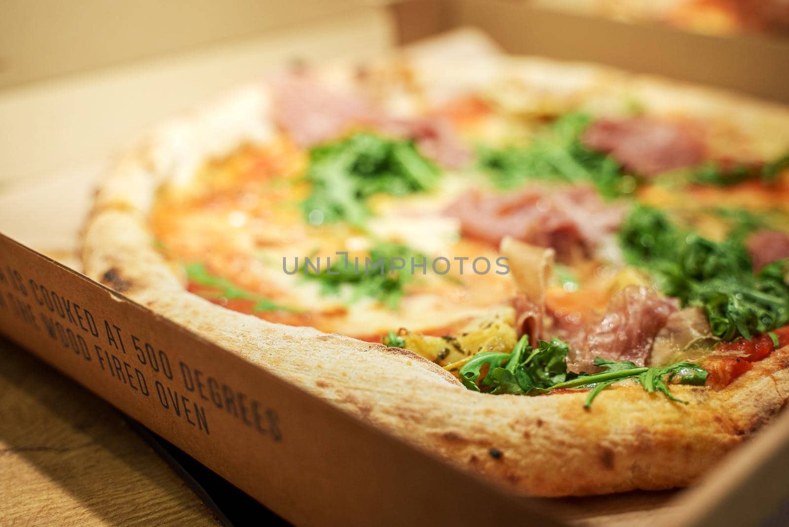 Freshly baked ordered pizza in a box. by dmitrimaruta