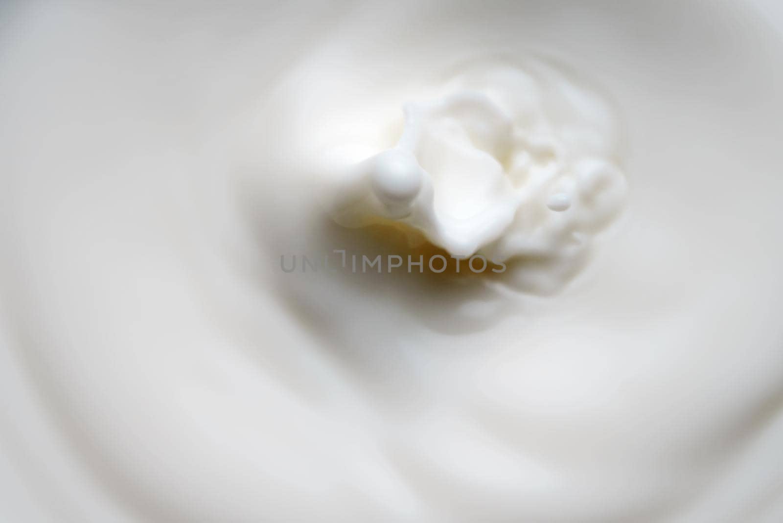 Milk or cream drop falls from the top. by dmitrimaruta