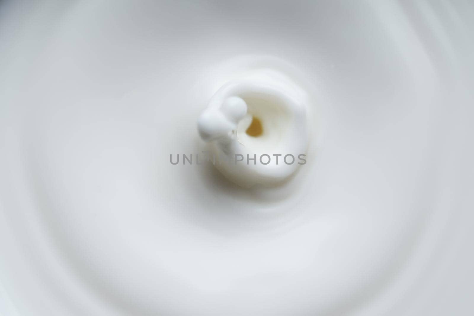 Milk or cream drop falls from the top. by dmitrimaruta
