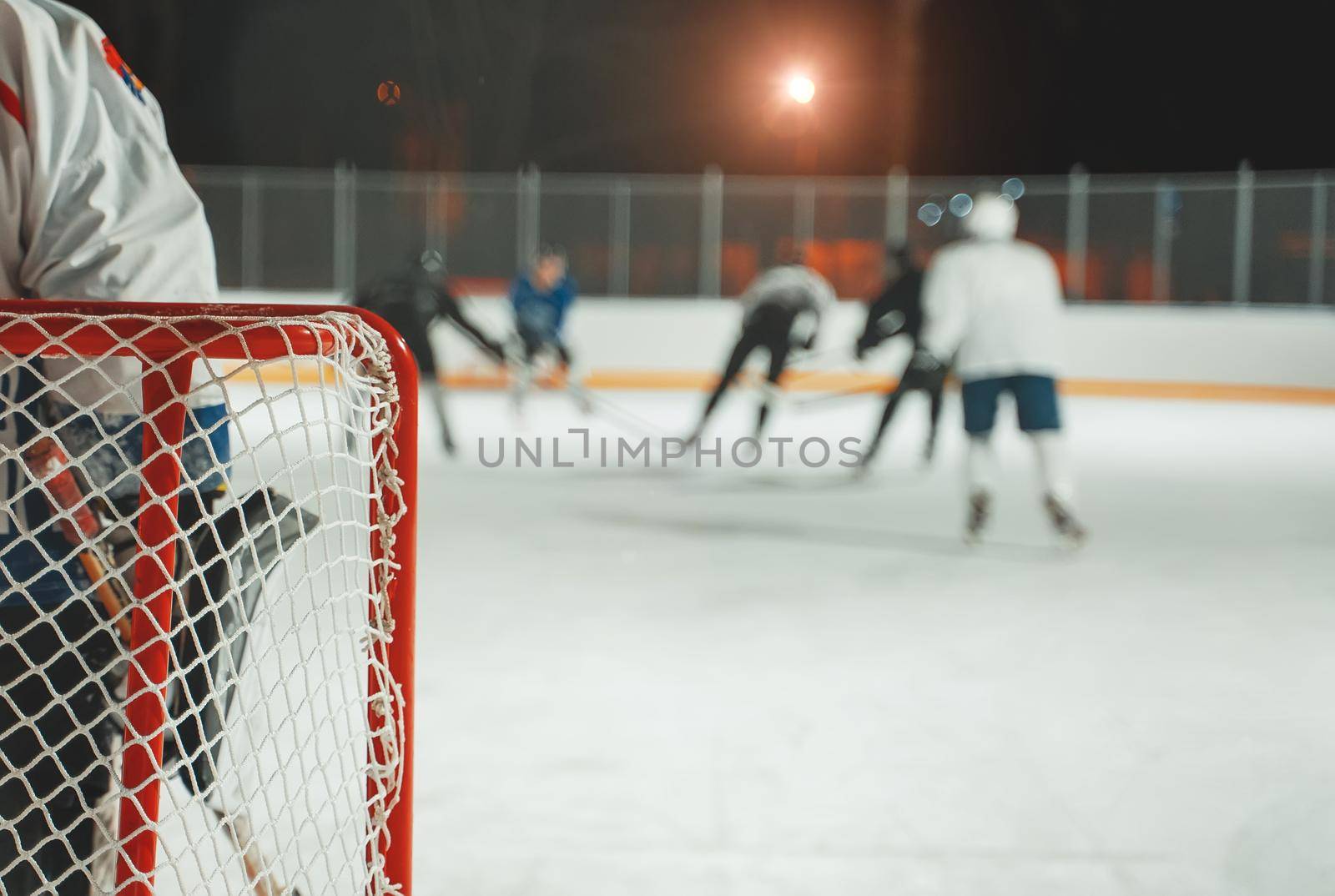 People play hockey outdoors in winter time. by dmitrimaruta