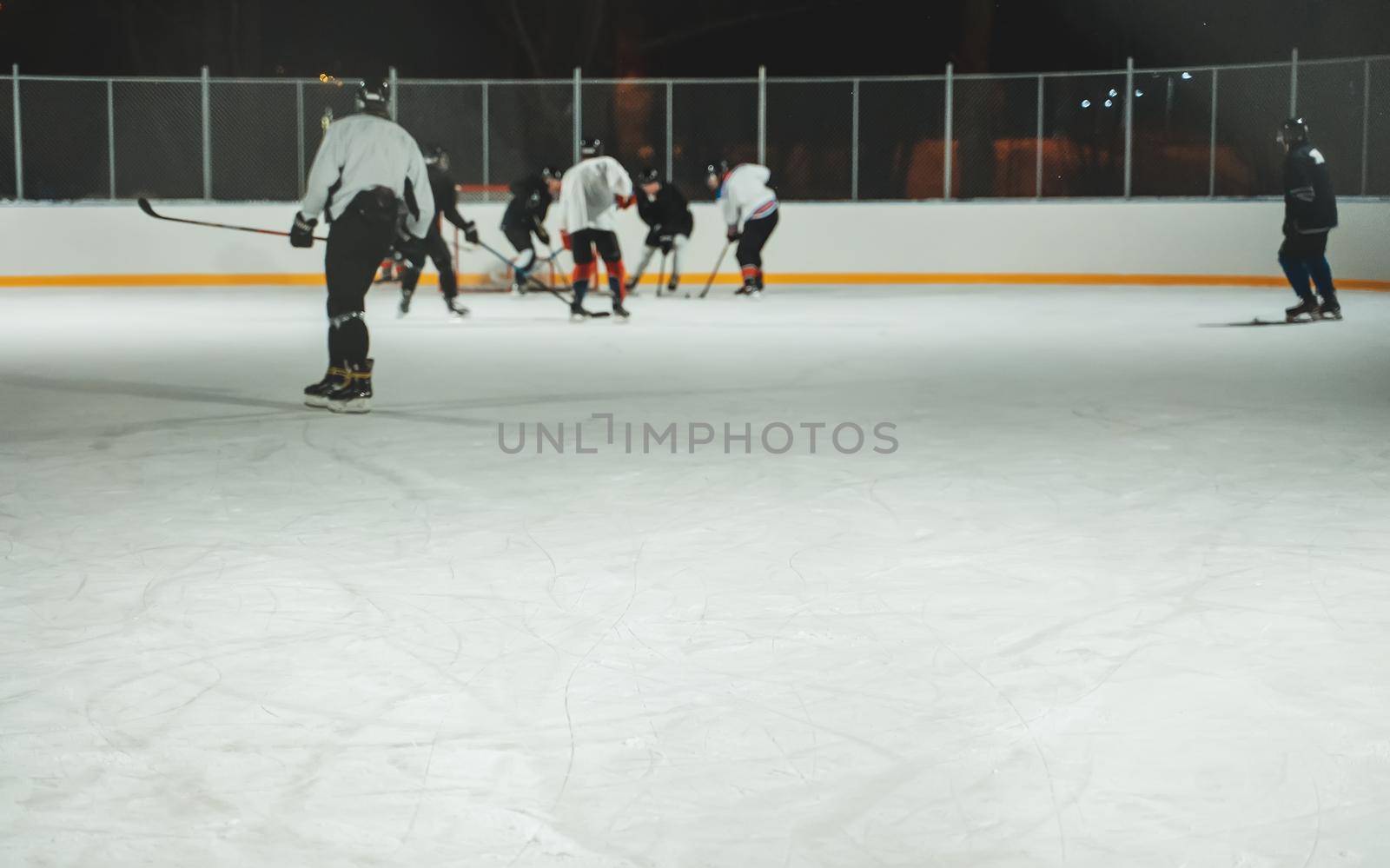 People play hockey outdoors in winter time. by dmitrimaruta