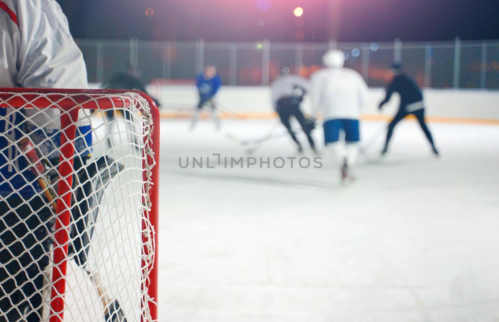 People play hockey outdoors in winter time.