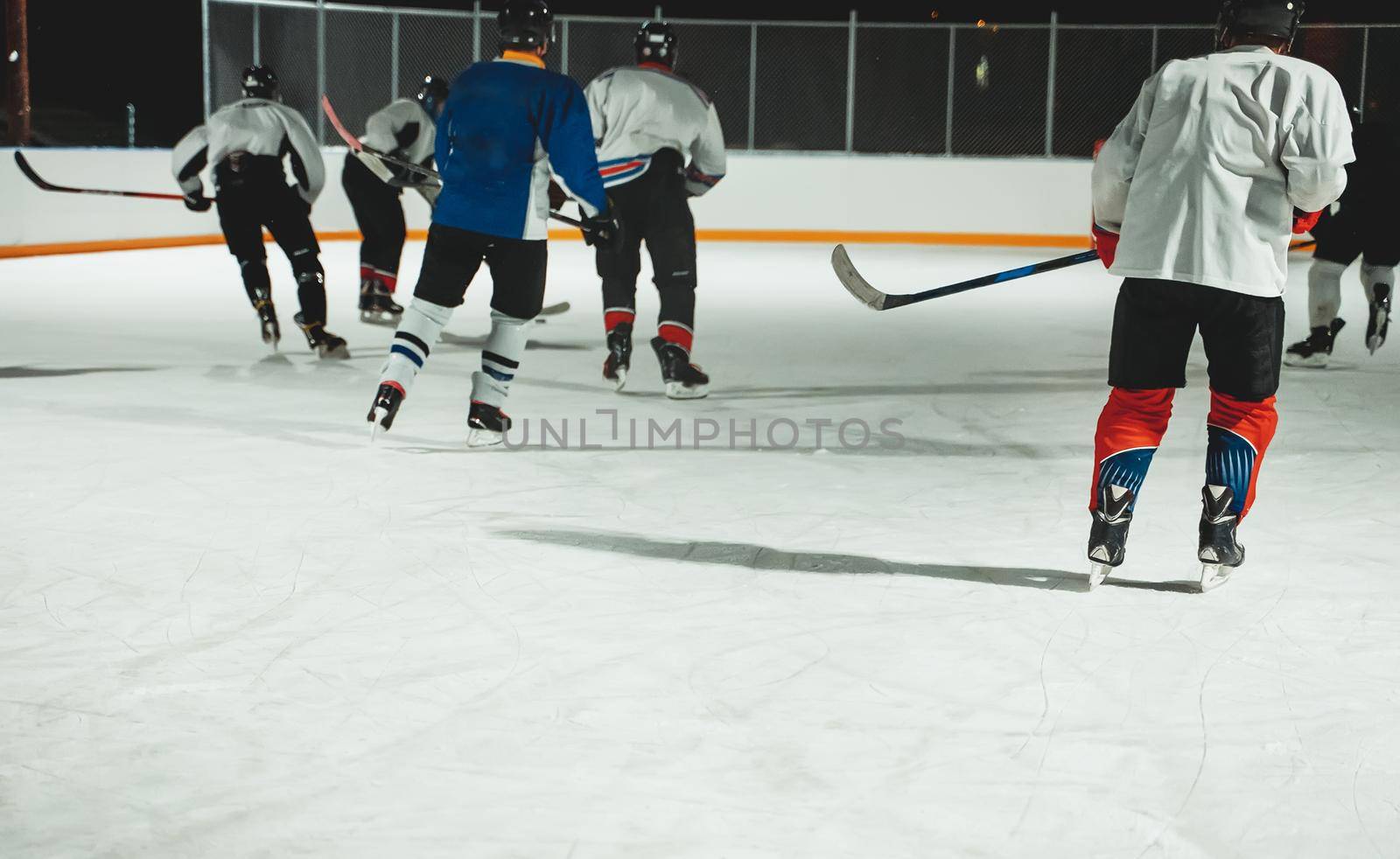 People play hockey outdoors in winter time.