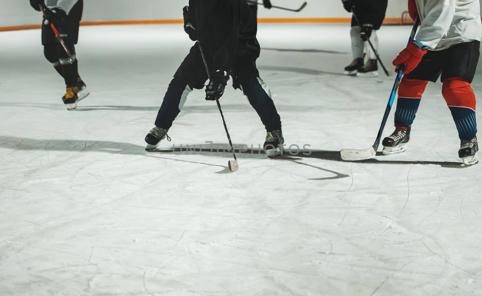 People play hockey outdoors in winter time.