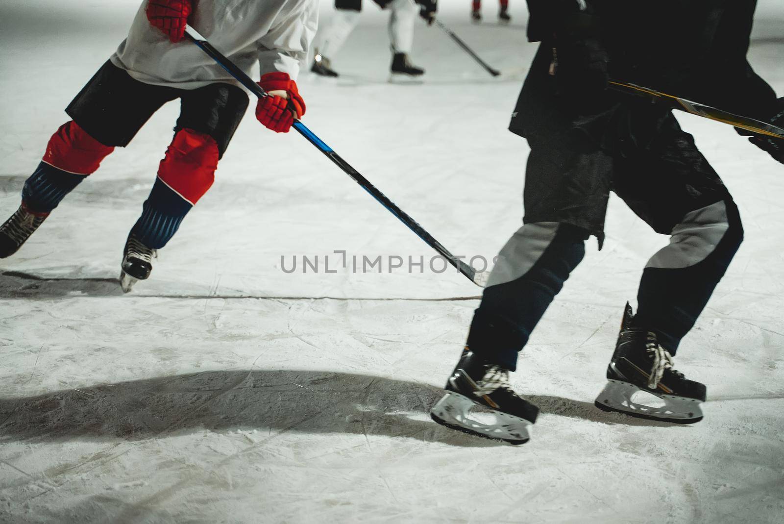 People play hockey outdoors in winter time. by dmitrimaruta