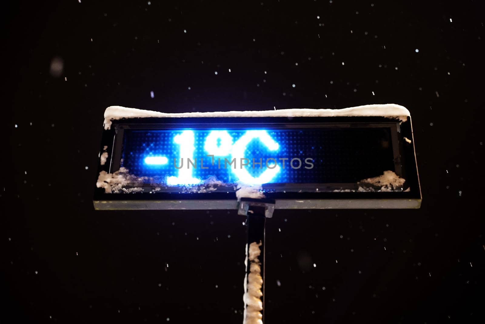 Outdoor thermometer shows a temperature of minus one degree.