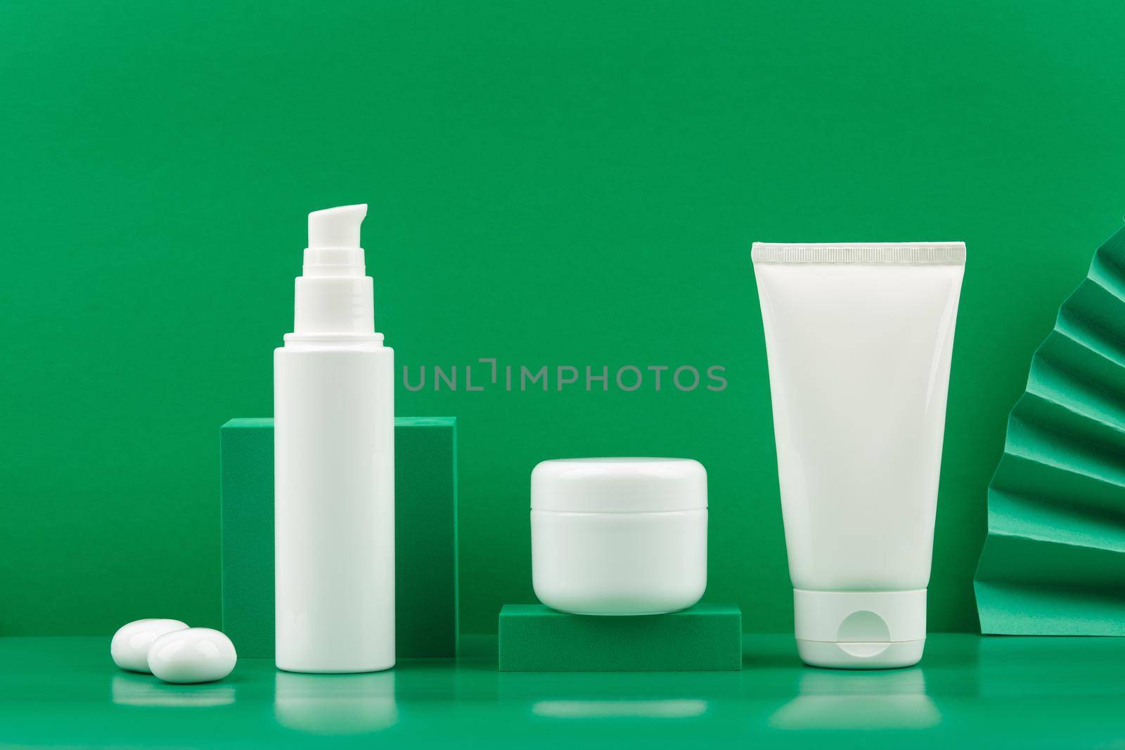 Still life with set of organic or eco friendly cosmetic products for skin care against green background. Concept beauty products with natural ingredients. 
