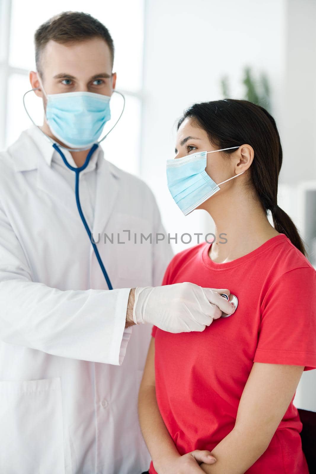 female patient for examination by doctor with stethoscope in hospital by SHOTPRIME