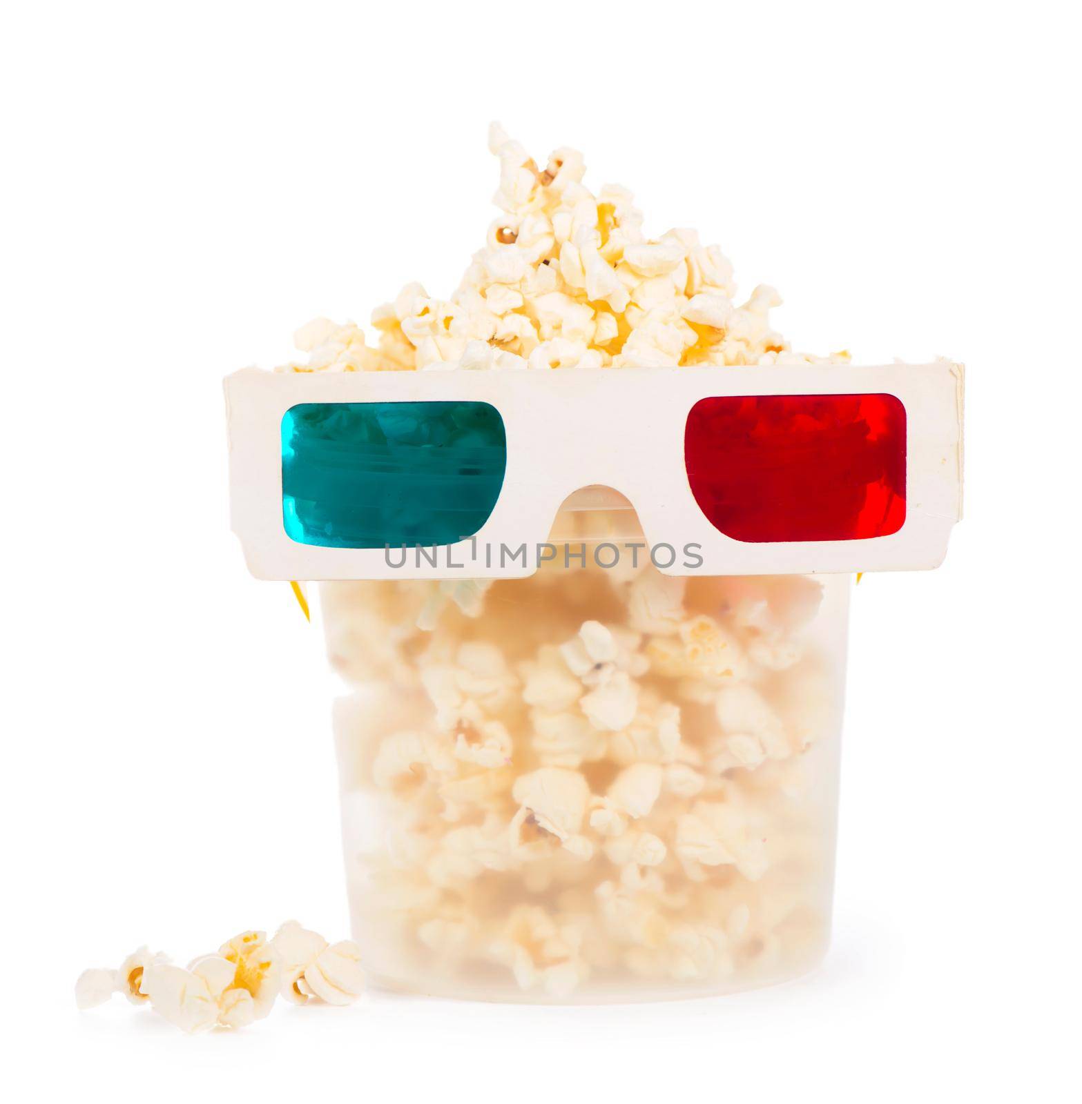 Paper striped bucket with popcorn and 3D glasses isolated on white background with clipping path. Concept of cinema or watching TV. by aprilphoto