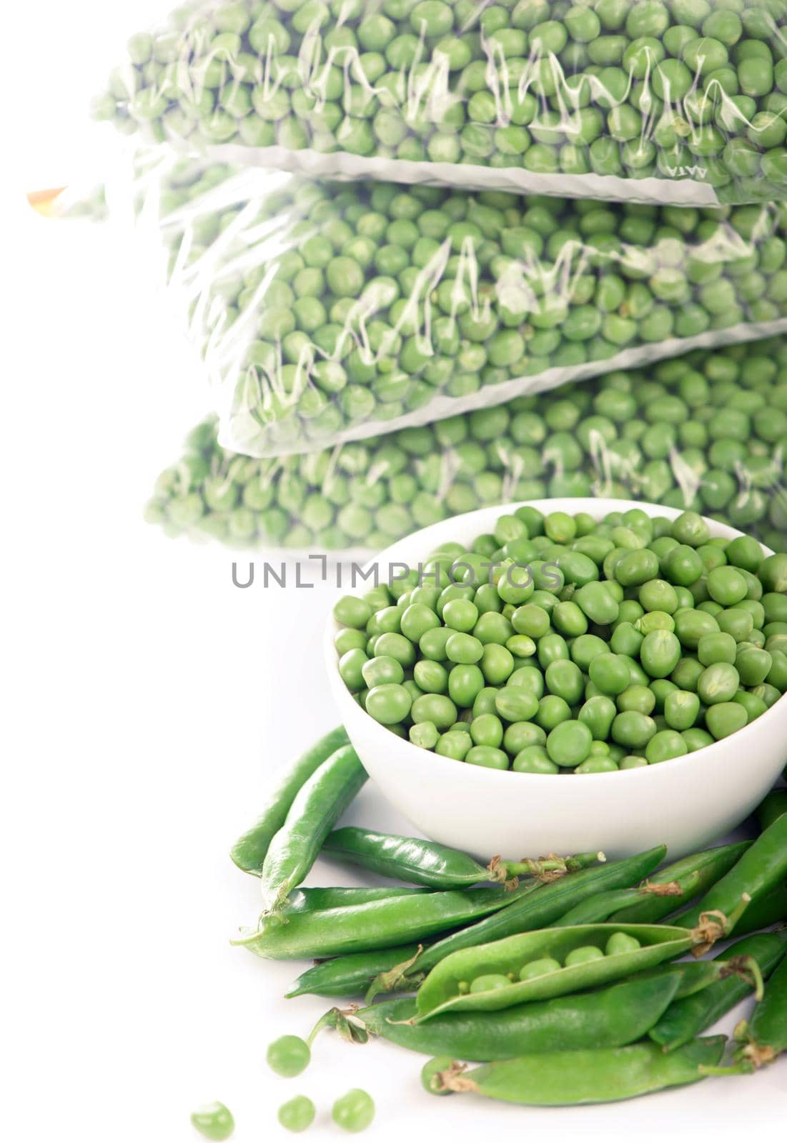 Composition with organic frozen vegetables on white background. Green peas in the package