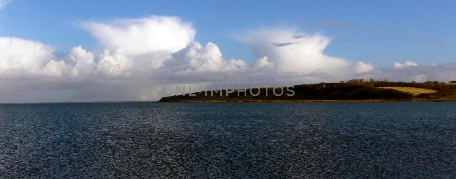 Panorama of white cloud and blue sky with sea on the coastline of Lemvig, Denmark