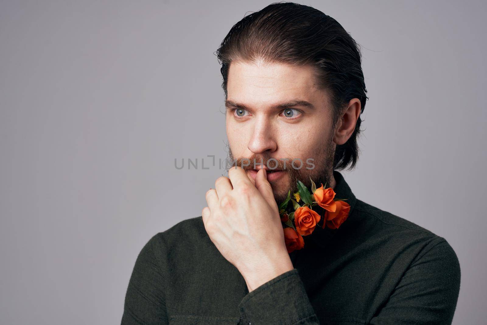 Cute elegant man in a black shirt flowers in a beard decoration romance gray background by SHOTPRIME