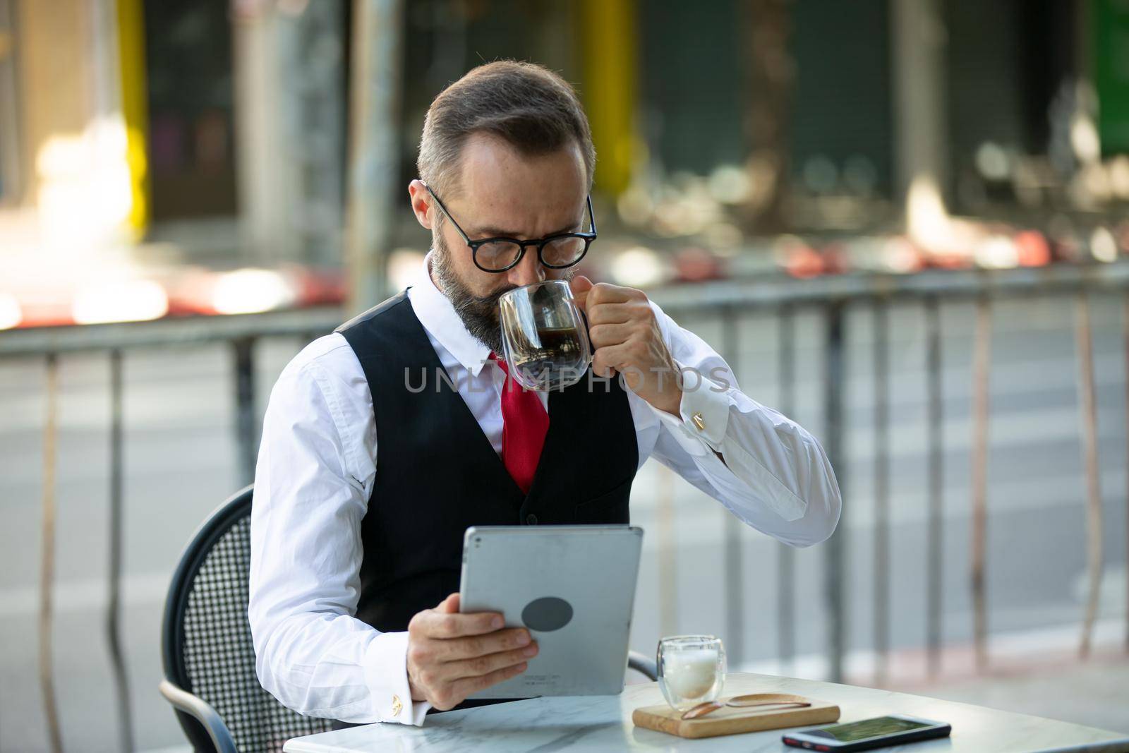 Business people talking in office using digital tablet and social media technology for communication.