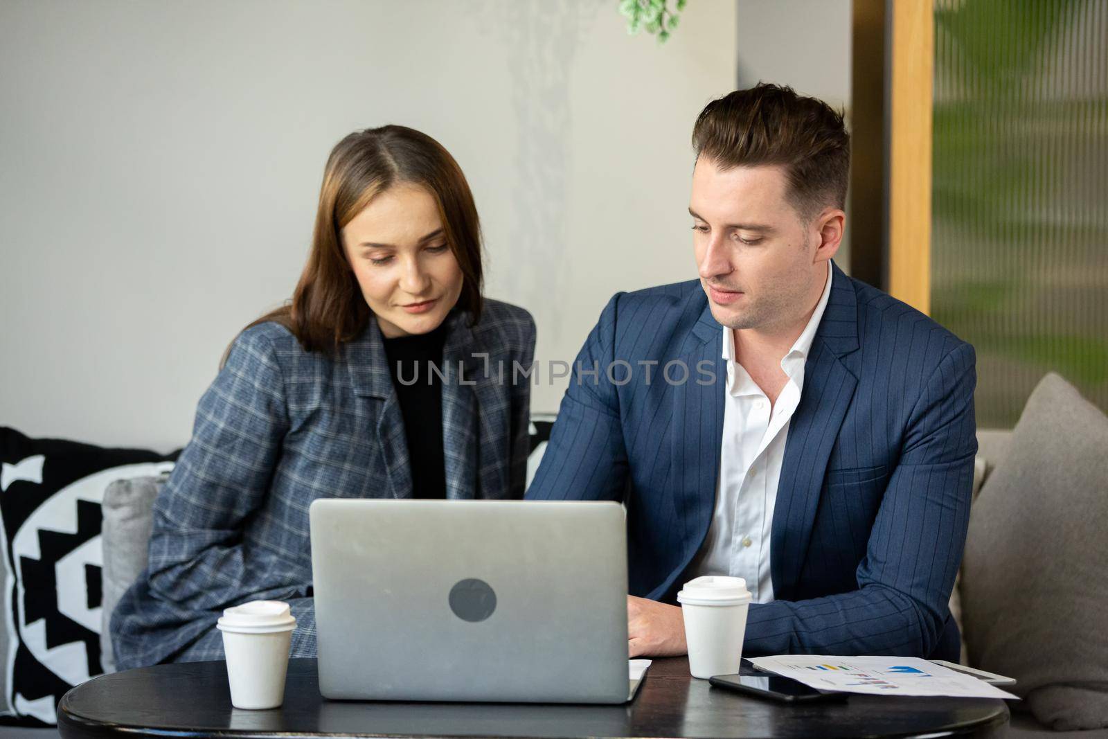Business people talking in office using digital tablet and computer 