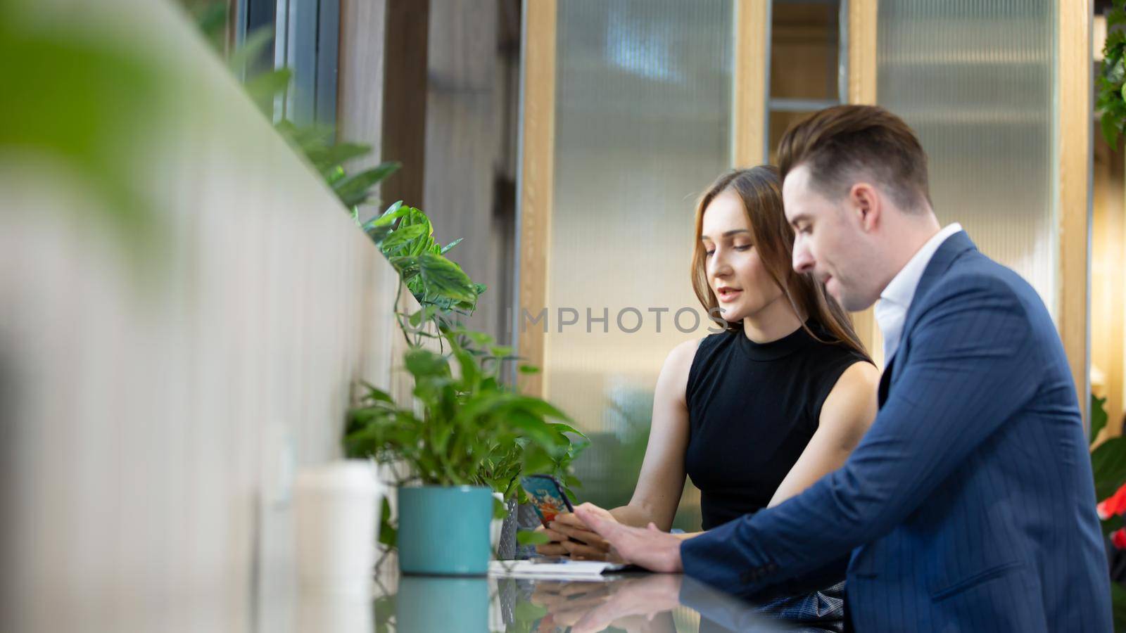 Business people talking in office using digital tablet and computer 