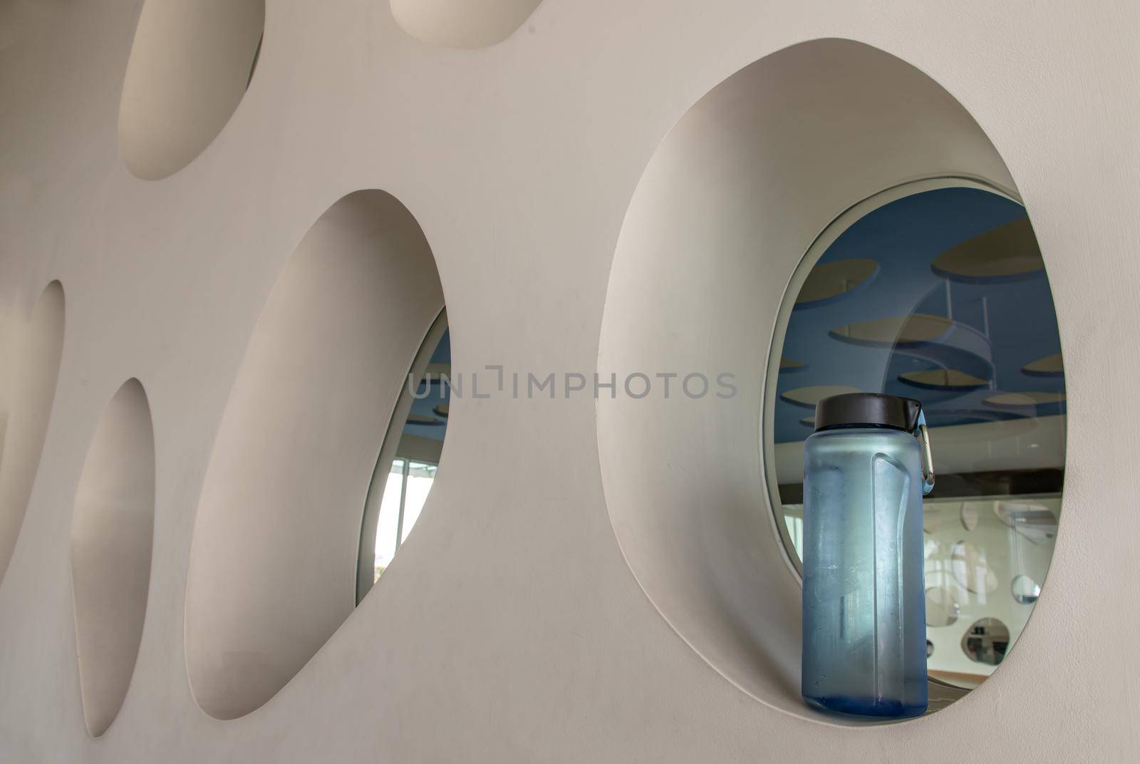 Sport water bottle in sport club or gym and fitness room with free space. Gym concept. Selective focus.