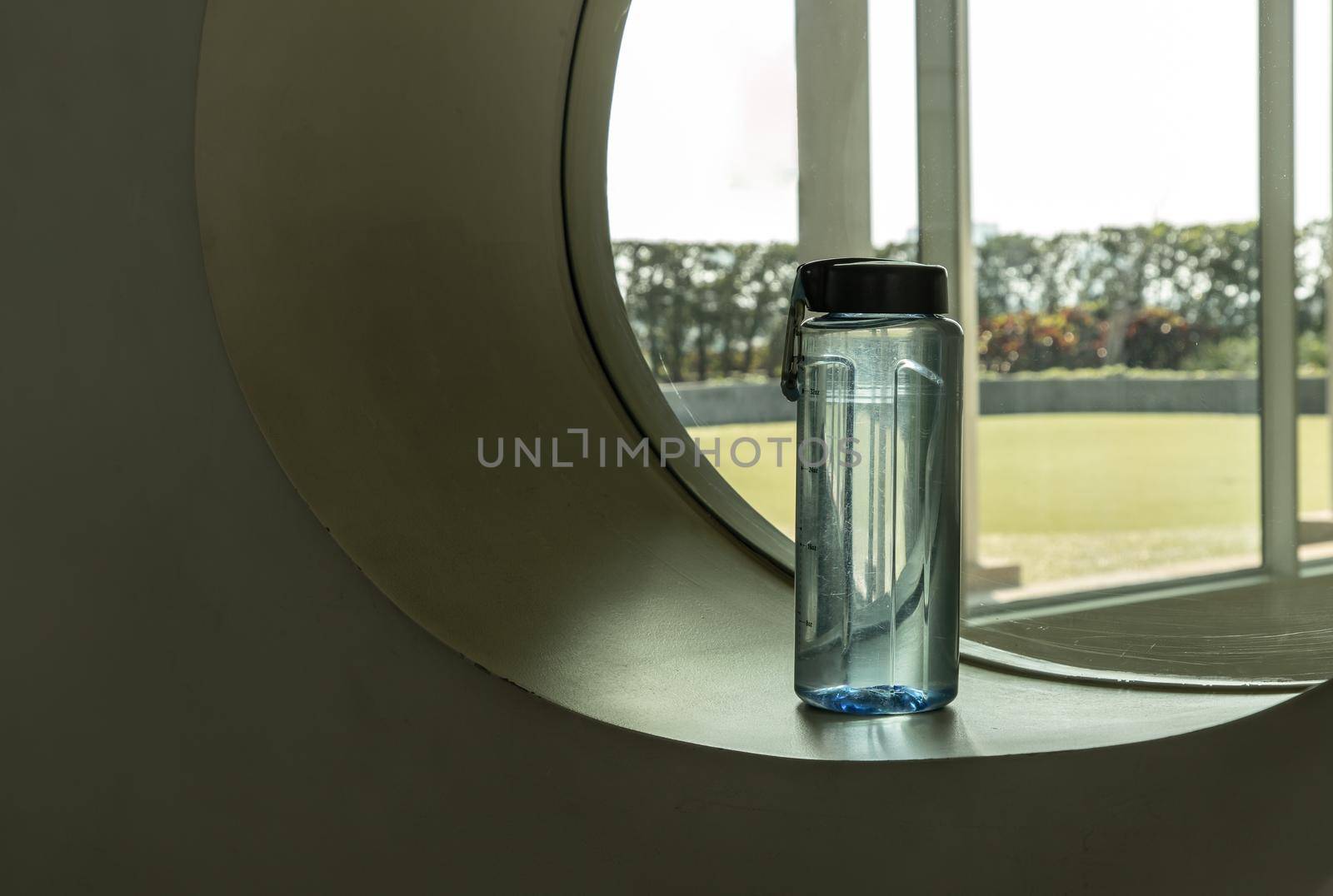 Sport water bottle in sport club or gym and fitness room with free space. Gym concept. Selective focus.