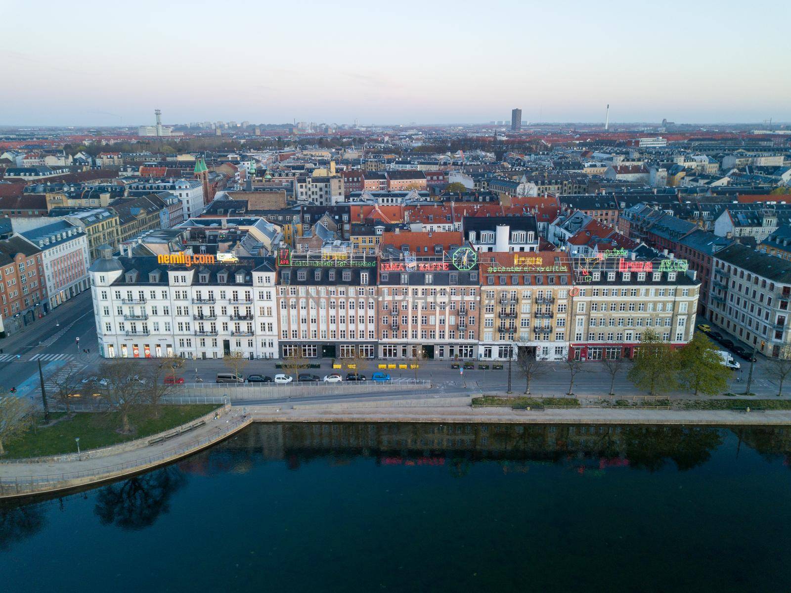Copenhagen, Denmark - April 17, 2020: Aerial drone view of neon light advertisement billboards on buildings at night