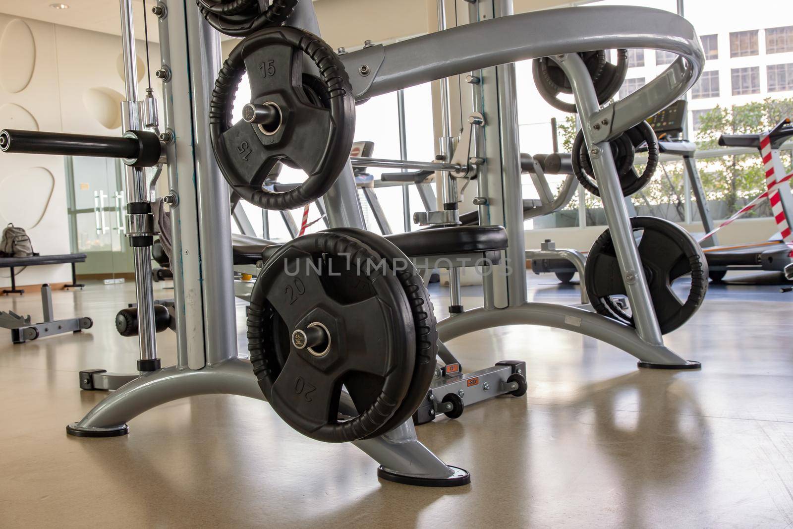Within gym or fitness studio with modern fitness equipment for fitness events and more. Modern of gym interior with equipment. Sports equipment in the gym. Selective focus.