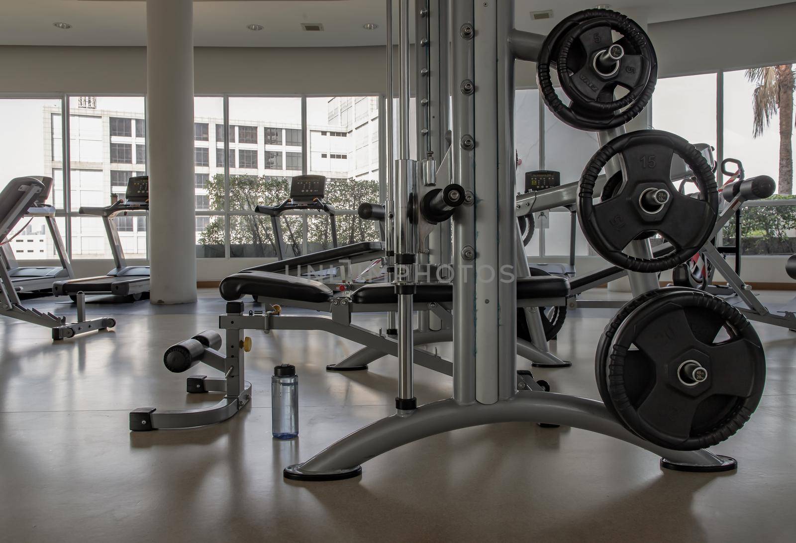 Within gym or fitness studio with modern fitness equipment for fitness events and more. Modern of gym interior with equipment. Sports equipment in the gym. Selective focus.