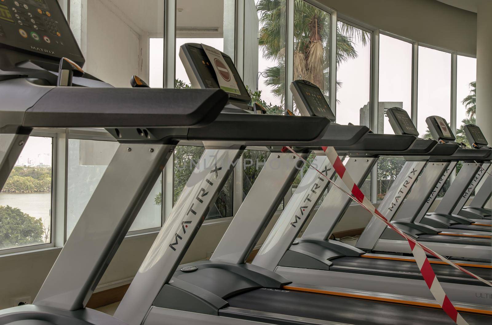 Bangkok, Thailand - 24 Jan 2021 : New normal concept and physical distancing people running in fitness and keep spaced to prevent from disease outbreak. New normal after COVID-19 pandemic concept. Social distance concept. Selective focus.