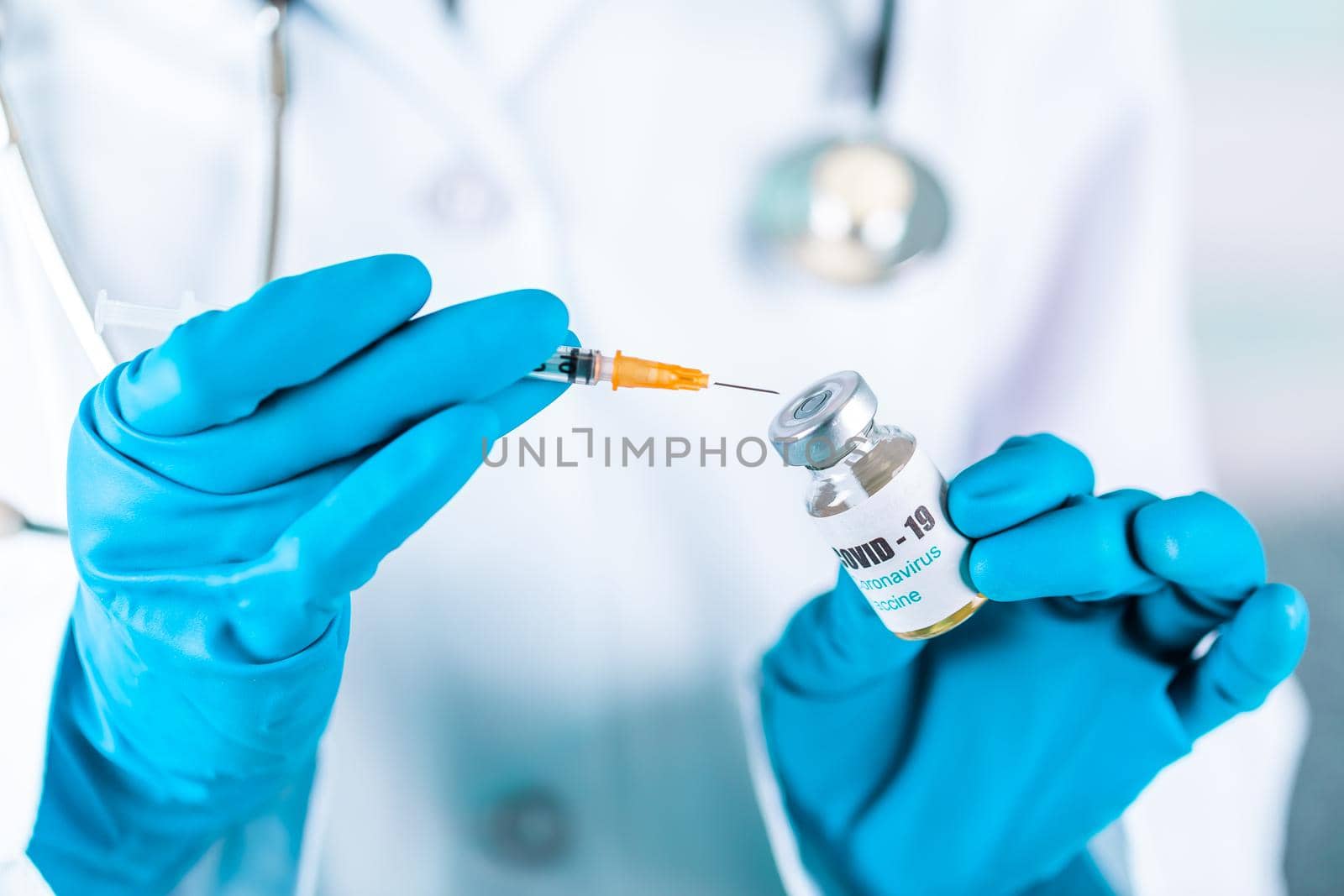 Woman doctor or nurse in uniform and gloves wearing face mask protective in lab, holding medicine vial vaccine bottle with COVID-19 Coronovirus vaccine label