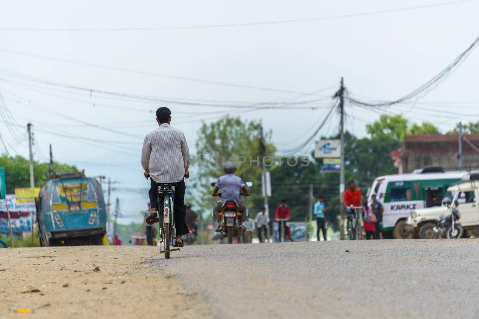TULSIPUR, NEPAL - CIRCA JULY 2015: Nepalese man cycling in Tulsipur, Dang District