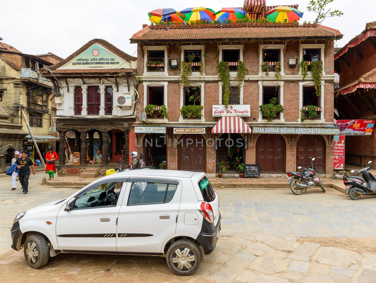 PATAN, NEPAL - CIRCA JUNE 2016: A Suzuki Maruti taxi and the Cafe du Temple on Patan Durbar Square.